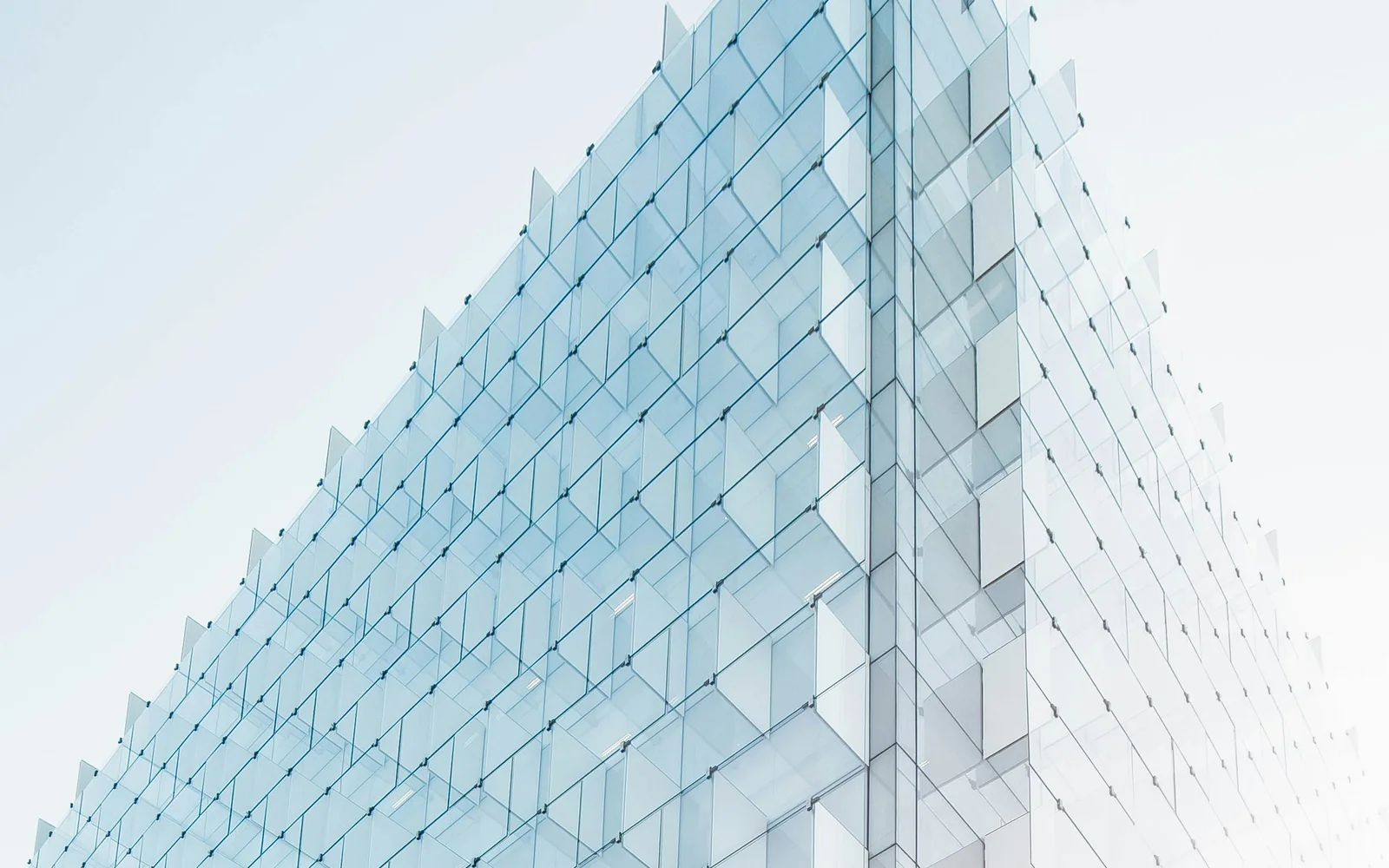 A contemporary glass infrastructure building against the sky